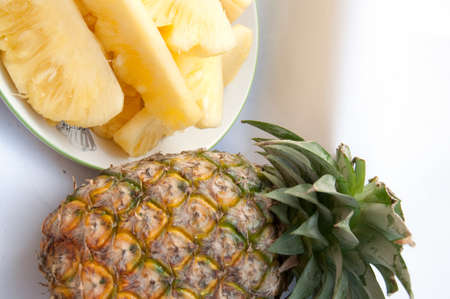 Dish with slices of pineapple on a white background の写真素材