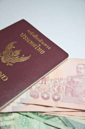 Thailand passport and Thai money on white backgroundの写真素材