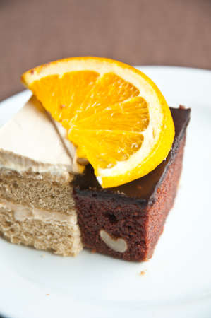 Chocolate and vanilla cake  and slice of orance