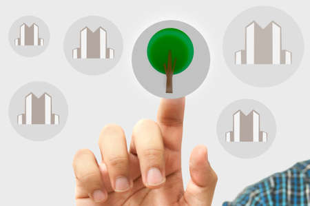 business man choose tree  or buildingの写真素材