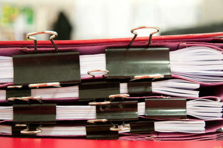 Black paperclip holding sheets of paperの写真素材