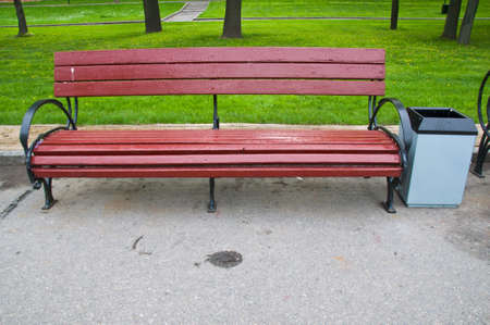 Wooden park bench in the garden and One Chairの写真素材