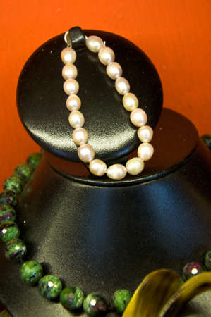 Pearl necklace on black mannequinの写真素材