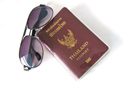 Thailand passport with sunglasses on white background