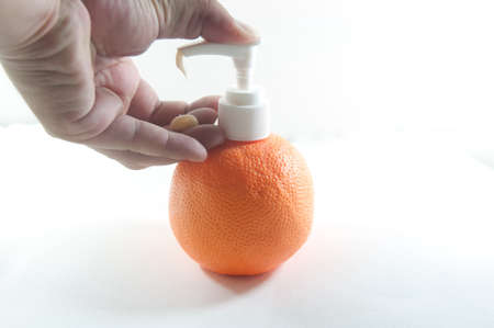 pressing the liquid soap to  handの写真素材
