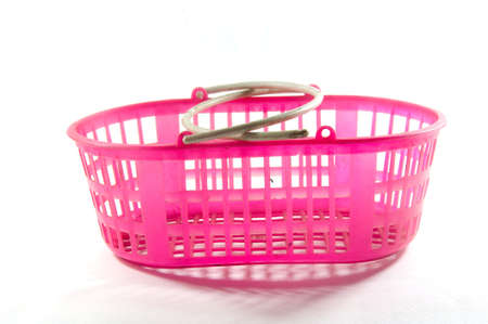 Pink shopping plastic basket on whiteの写真素材