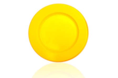 yellow plastic dish on white backgroundの写真素材
