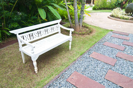 white wooden bench beside in the parkの写真素材