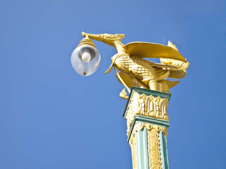 thai style light pillar lantern with blue skyの写真素材