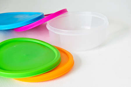 Colourful plastic containers isolated on a white backgroundの写真素材