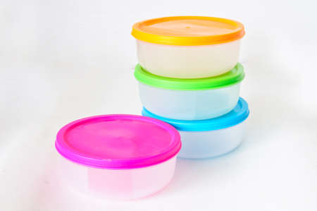 Colourful plastic containers isolated on a white backgroundの写真素材