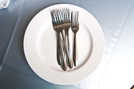 Plates and cutlery on tableの写真素材