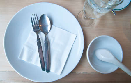 empty white plate with silver spoonの写真素材