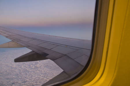 Clouds and sky as seen through window of an aircraft in night