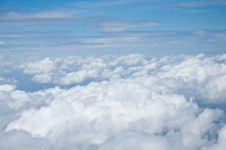 View at earth from airplane window above the cloudsの写真素材