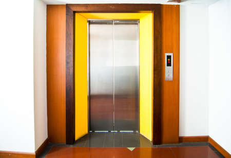 Front view of a modern elevator with closed doors in lobbyの写真素材