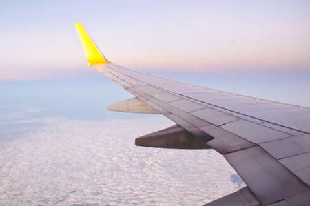 Clouds and sky as seen through window of an aircraftの写真素材