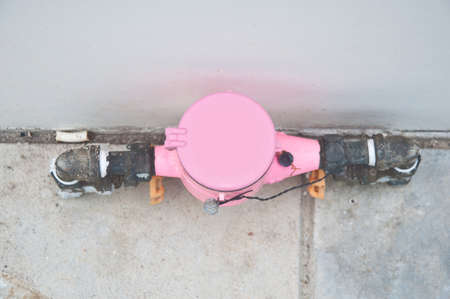 Pink water meter and plumbingの写真素材