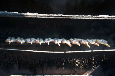 Grilling chicken plugged with bamboo, Local Foods of Thailandの写真素材