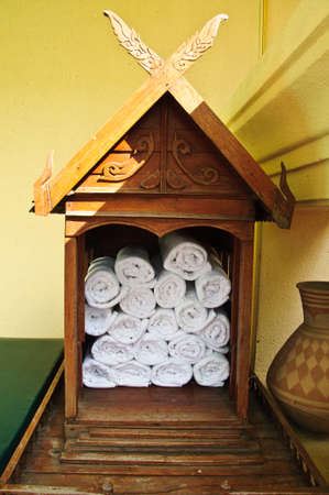 Big bunch of white towels in wood bathroom shelfの写真素材