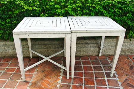old two white table in gardenの写真素材