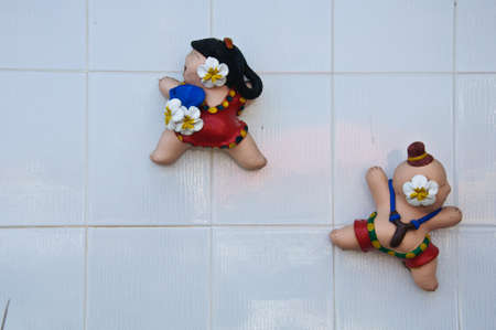 The little boy and gril statue with slingshot to fun and happy-Thaiの写真素材