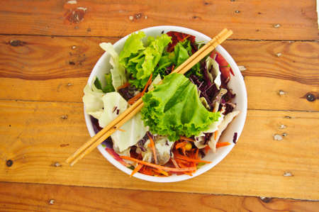 Delicious vegetable salad on wood tableの写真素材