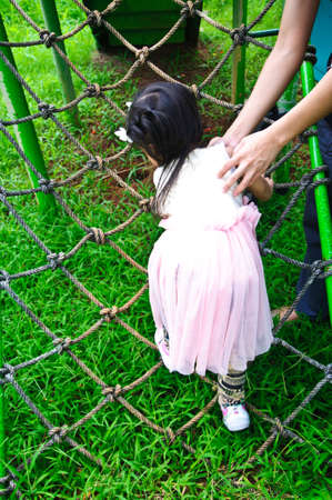 The girl with plait plays on playgroundの写真素材