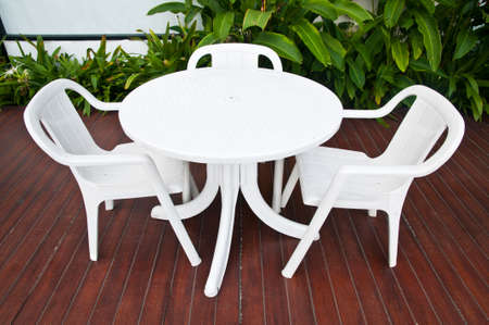 Table with chairs standing against the swimming poolの写真素材