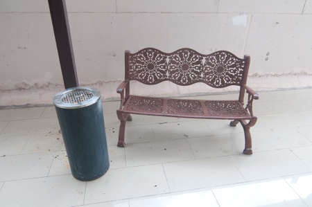 smoking area outside modern office building a metal bench with a large ash trayの写真素材