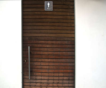 WC symbol- man toilet in door woodの写真素材