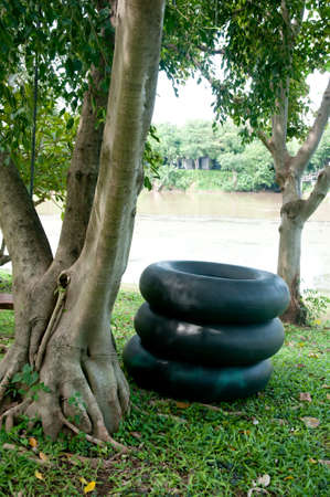 Stack of rubber tires in river for swimmingの写真素材