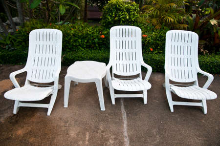 Relaxing seats standing against the swimming poolの写真素材