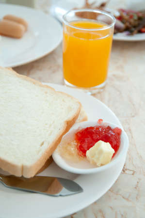 Breakfast - toasts , Orange juice  and strawberry jamの写真素材