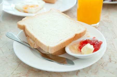 Breakfast - toasts , Orange juice  and strawberry jamの写真素材