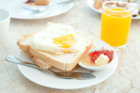 Fried eggs with hotdog Orange juice and toastsの写真素材