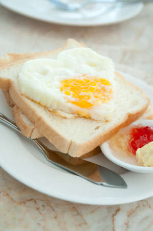 Breakfast - toasts, egg and strawberry jamの写真素材
