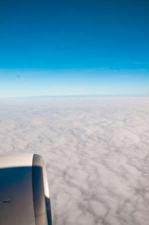 Clouds and sky as seen through window of an aircraftの写真素材