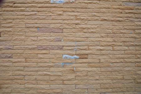 Weathered stained old brick wall backgroundの写真素材