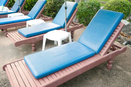 chaise longues beside swimming pool.の写真素材