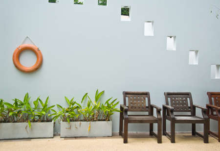 wood chair beside swimming poolの写真素材