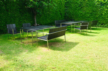 business patio with table and chairs in gardenの写真素材