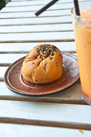 Romantic breakfast Refreshing cold frappe tea and bread on tableの写真素材