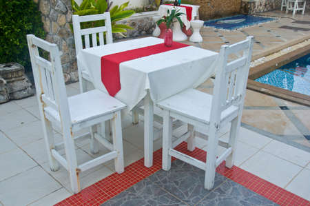 Outdoor white wooden table and chair in the hotel の写真素材