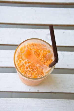 A glass of iced thai milk teaの写真素材