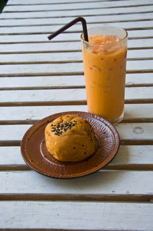 Breakfast with toast and Thai milk Iced Teaの写真素材