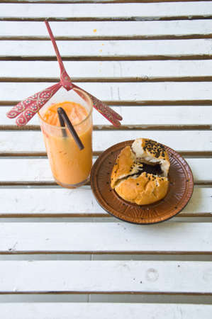 Ice Thai tea and Chocolate bun in coffee shopの写真素材