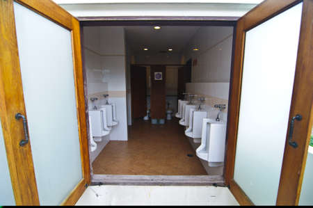 white porcelain urinals in public toiletsの写真素材