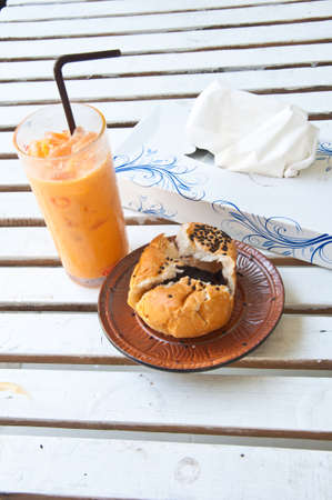 Refreshing  tea and bread on tableの写真素材