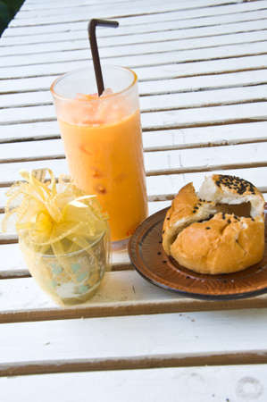 Refreshing cold frappe coffee and Chocolate bun in coffee shopの写真素材